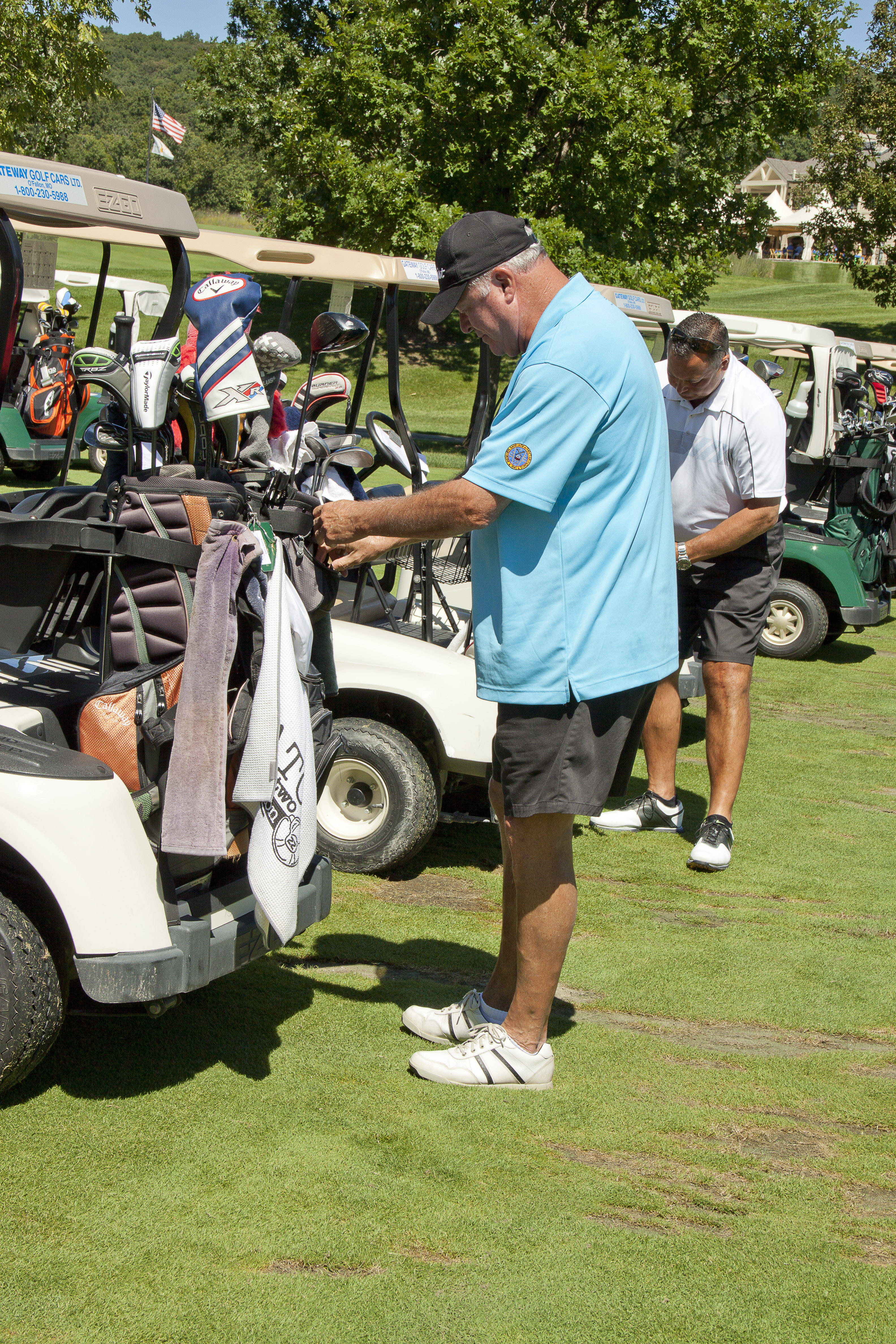 Another golfer checks his bags.